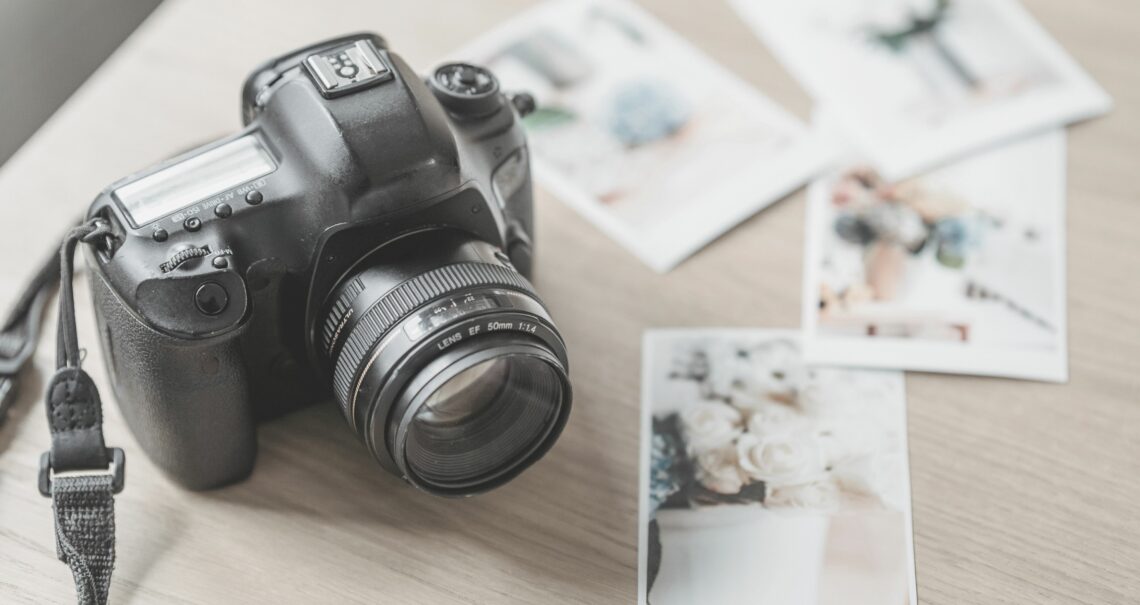 Photo camera with printed photos von George Melton von Pexels